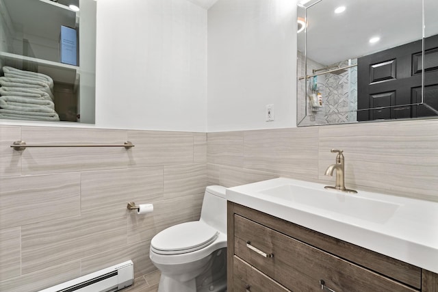 full bathroom with a shower, toilet, a baseboard radiator, vanity, and tile walls