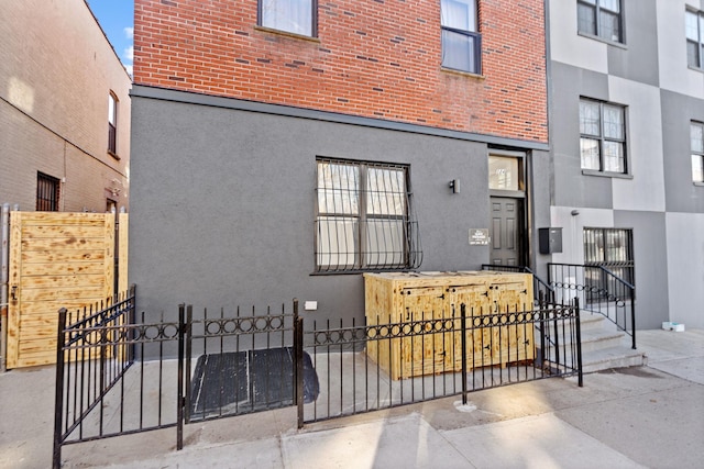 exterior space featuring a fenced front yard and stucco siding