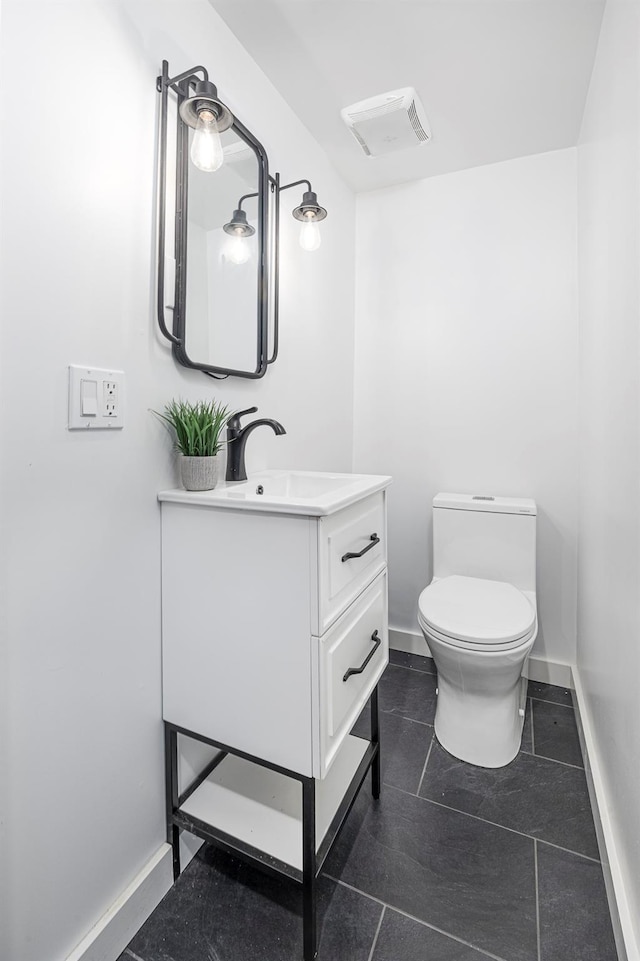 bathroom with baseboards, visible vents, toilet, tile patterned floors, and vanity