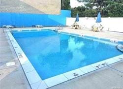 pool with fence and a patio