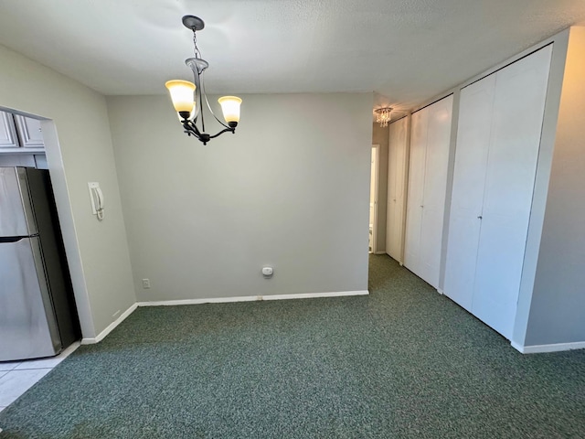 interior space with carpet floors, a chandelier, and baseboards