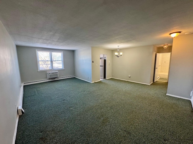 empty room featuring baseboards, a textured ceiling, dark carpet, a notable chandelier, and a wall mounted AC