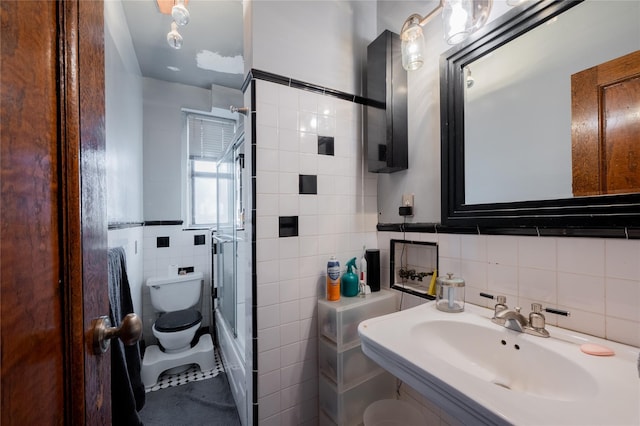 full bathroom with a shower with door, a sink, tile walls, and toilet