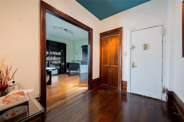 entryway featuring dark wood-type flooring and rail lighting