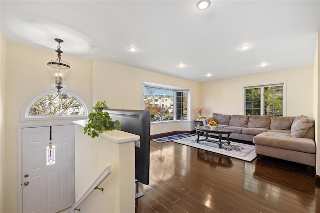 living room featuring dark wood-type flooring and recessed lighting