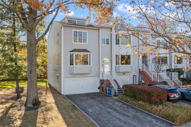 view of front of property featuring driveway, stairway, and an attached garage