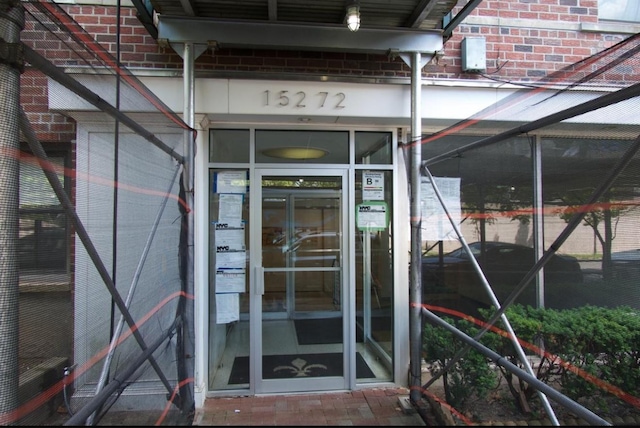 property entrance featuring brick siding