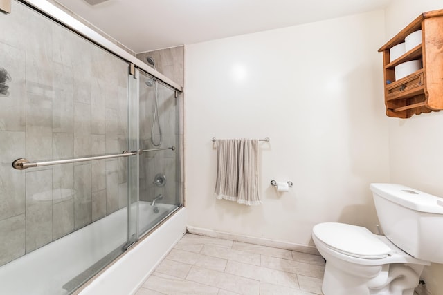 bathroom with baseboards, enclosed tub / shower combo, and toilet