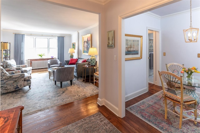 interior space featuring a chandelier, ornamental molding, radiator heating unit, and wood finished floors