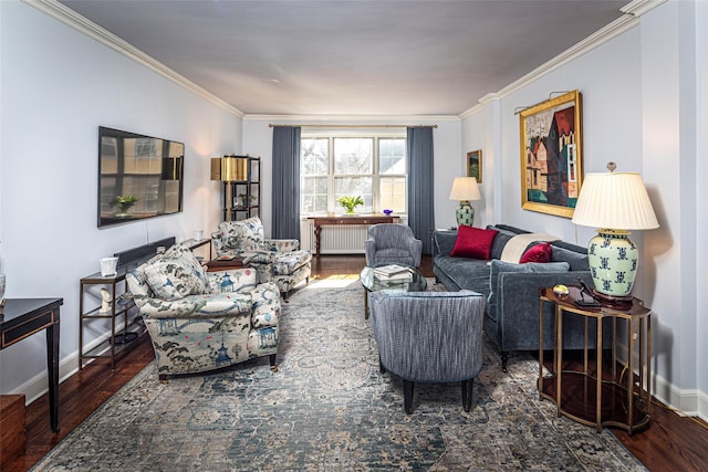 living room with radiator heating unit, crown molding, baseboards, and wood finished floors