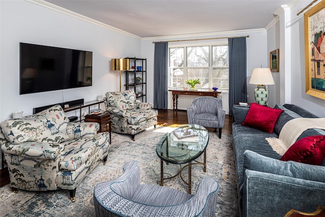 living area featuring radiator heating unit, crown molding, and wood finished floors