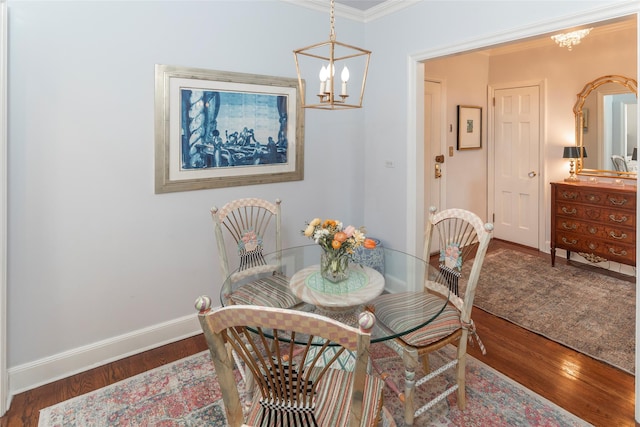 dining space with wood finished floors, baseboards, and an inviting chandelier