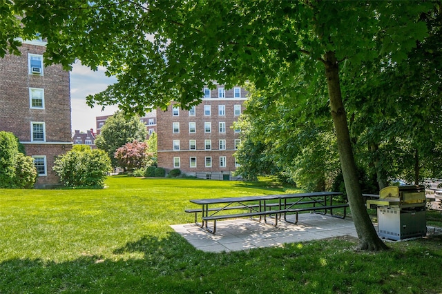 surrounding community with a patio area and a yard