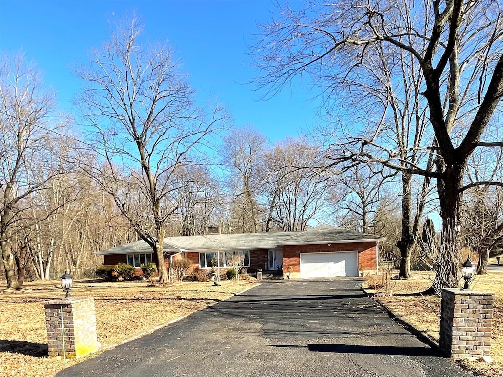 ranch-style home with driveway and a garage