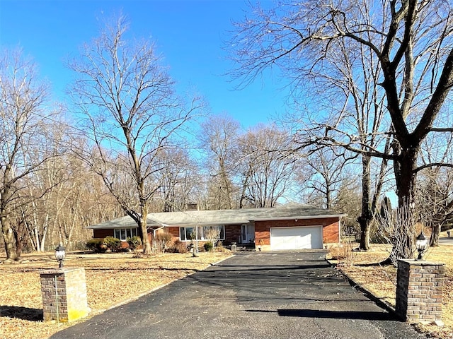 ranch-style home with driveway and a garage