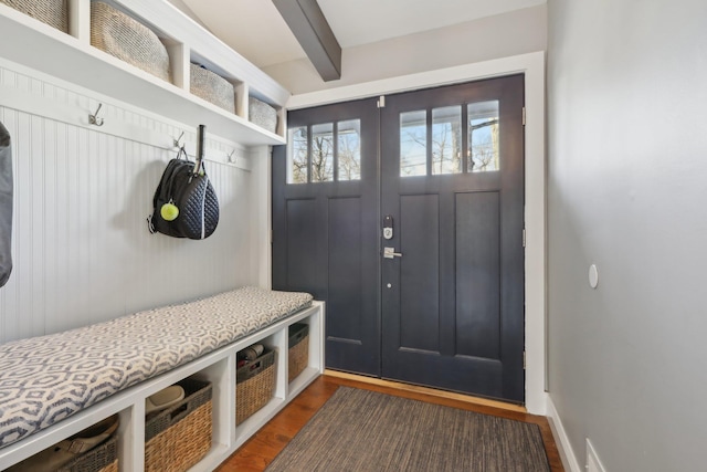 mudroom featuring dark wood-type flooring and beamed ceiling