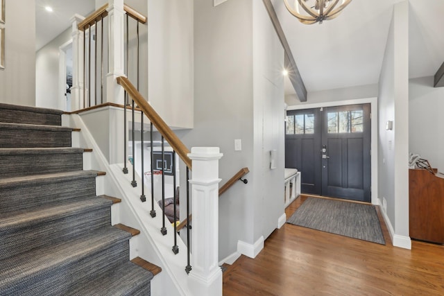 entrance foyer featuring baseboards and wood finished floors