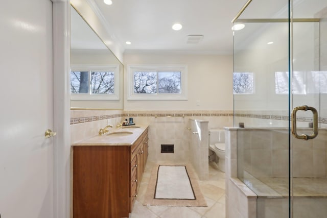 bathroom featuring crown molding, double vanity, visible vents, toilet, and a sink