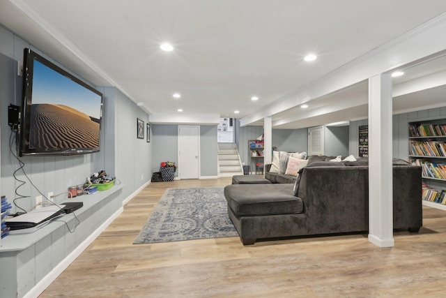 living room with stairs, light wood-type flooring, ornamental molding, and recessed lighting