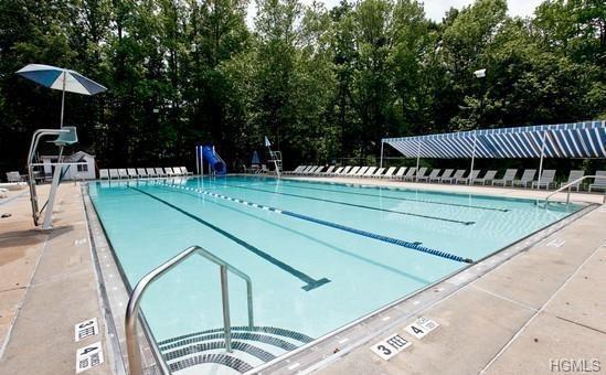 pool featuring a patio and a water slide