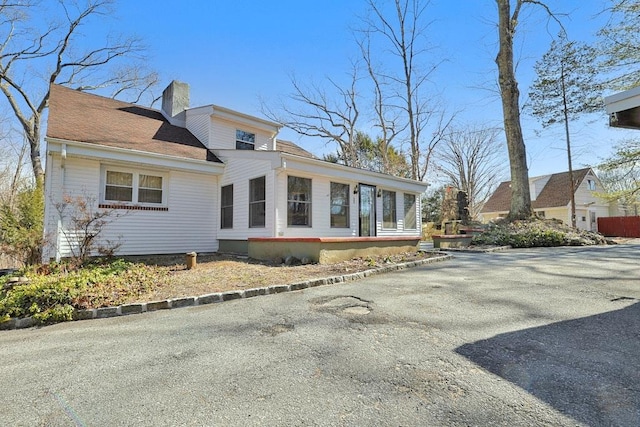 view of side of home with a chimney