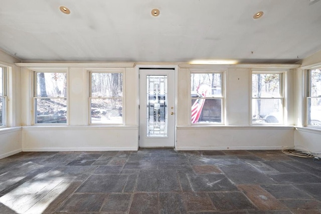 unfurnished sunroom with a healthy amount of sunlight and vaulted ceiling