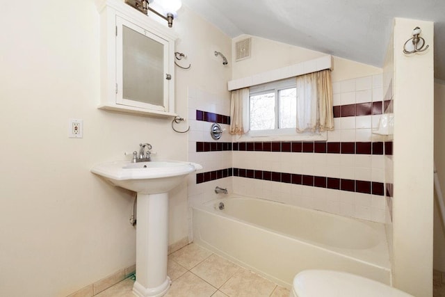 full bathroom featuring tile patterned floors, visible vents, toilet, baseboards, and lofted ceiling