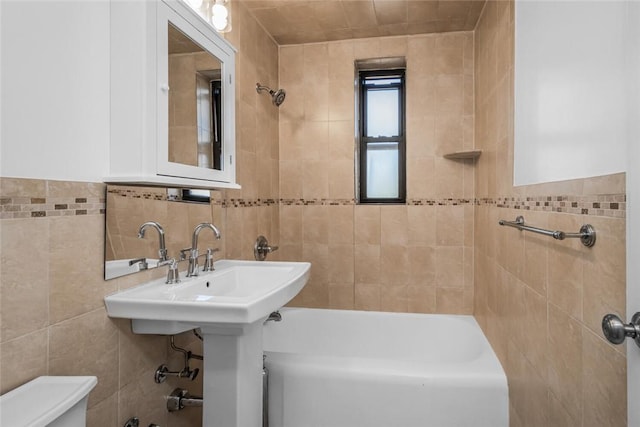 full bathroom featuring toilet and tile walls