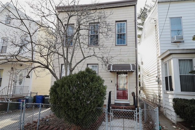 view of front of home featuring entry steps, a fenced front yard, and cooling unit