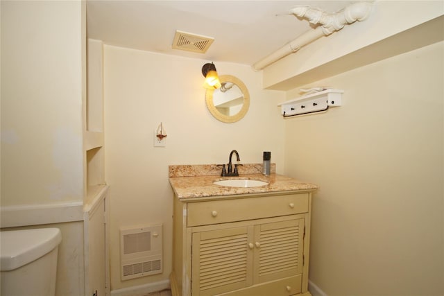 bathroom featuring visible vents, vanity, and toilet