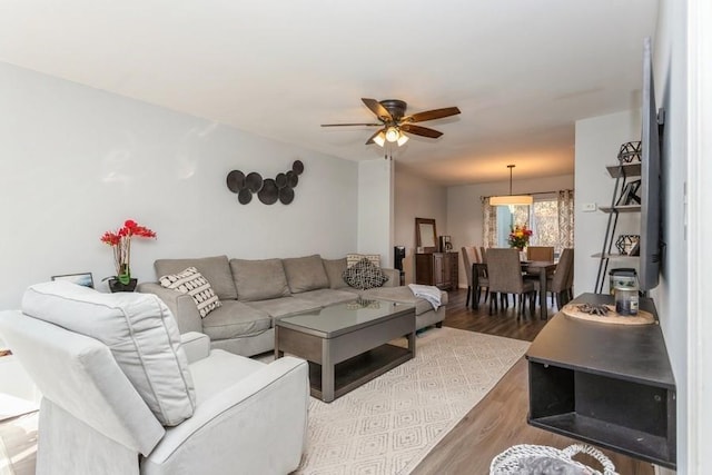 living area featuring a ceiling fan and wood finished floors