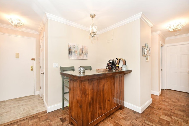 interior space featuring hanging light fixtures, baseboards, and ornamental molding