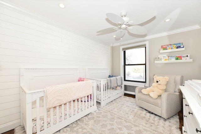 bedroom with a nursery area, ornamental molding, a ceiling fan, and recessed lighting