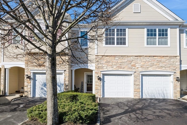 view of front of house featuring a garage and aphalt driveway