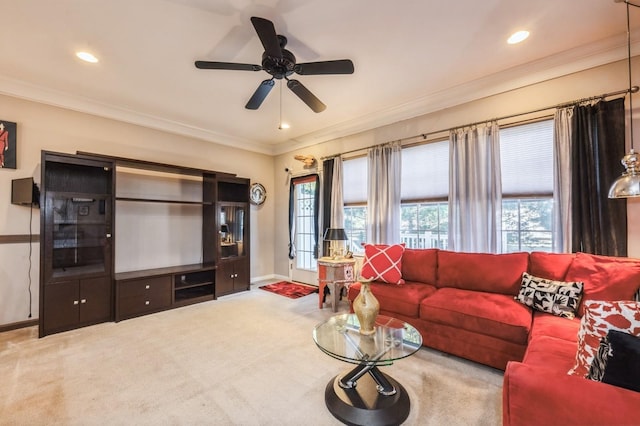 living area featuring carpet floors, ornamental molding, plenty of natural light, and baseboards