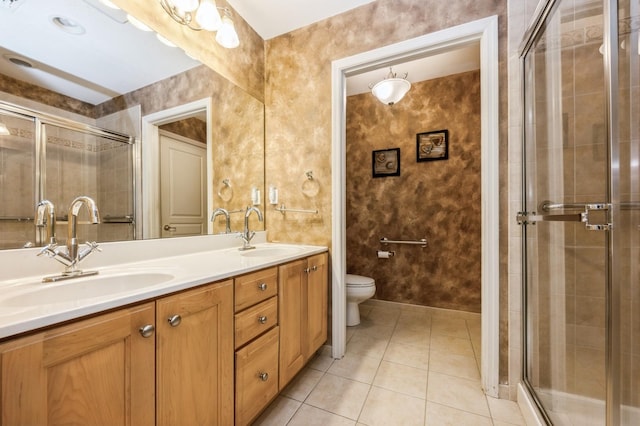 bathroom with tile patterned flooring, a sink, and a shower stall