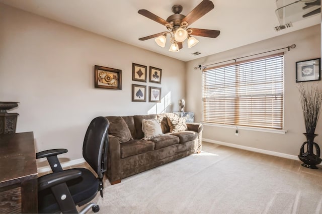 office area featuring baseboards, carpet floors, visible vents, and a ceiling fan