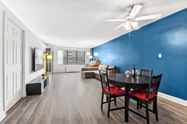 dining space featuring ceiling fan, baseboards, and wood finished floors