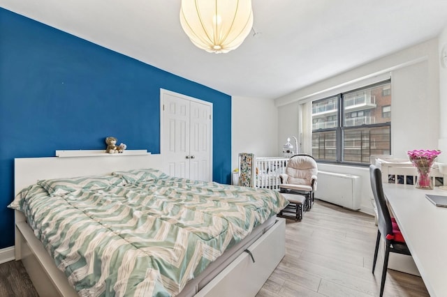 bedroom featuring a closet and wood finished floors