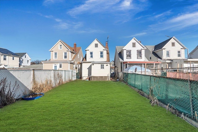 view of yard featuring a residential view and a fenced backyard