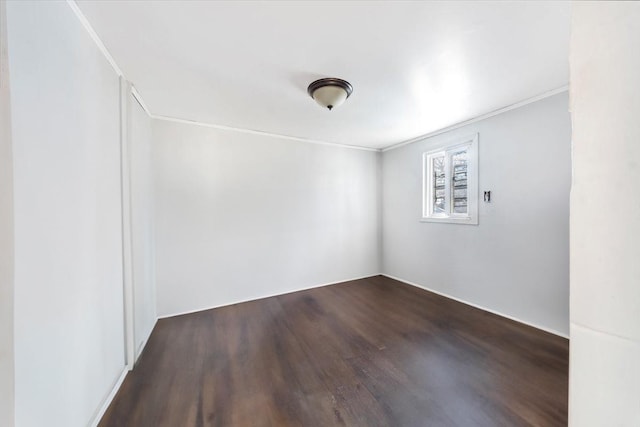 unfurnished room with dark wood-style floors and ornamental molding