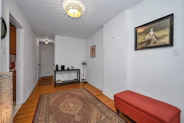 corridor featuring baseboards and light wood-style floors