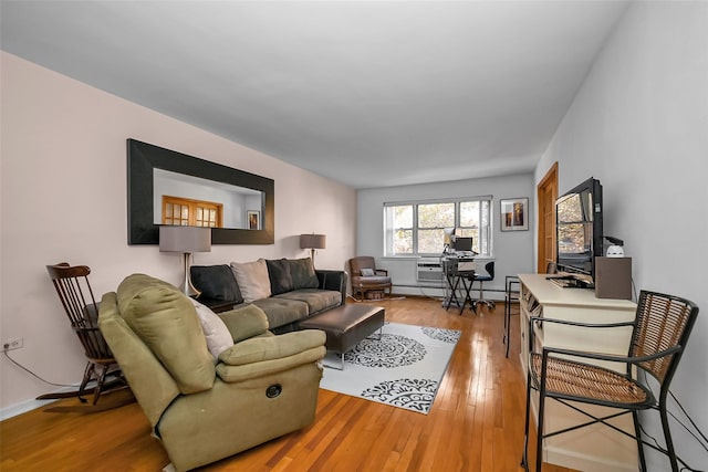 living room featuring light wood-style flooring and baseboard heating