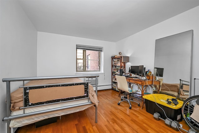 office space with baseboard heating and wood finished floors