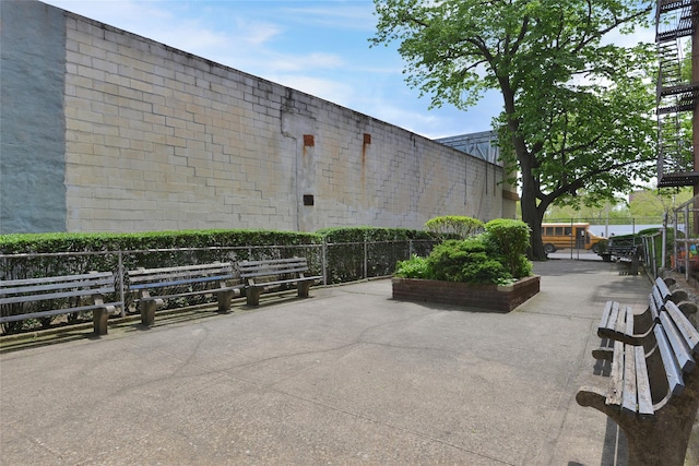 view of community with fence and a patio