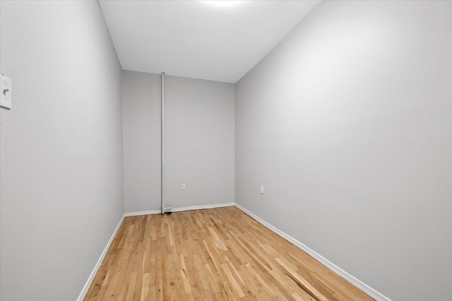 spare room featuring light wood-style floors and baseboards