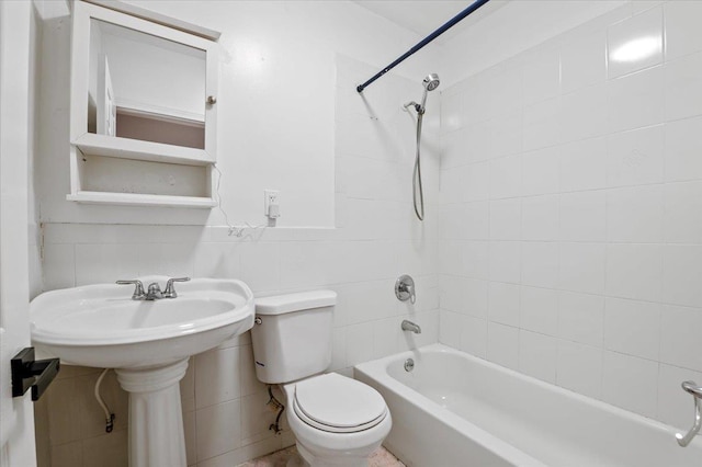 full bathroom with washtub / shower combination, tile walls, and toilet