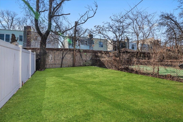 view of yard with a fenced backyard