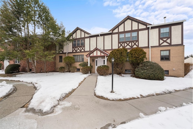 view of front of property featuring stucco siding and brick siding