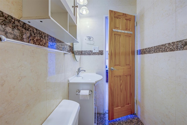 half bathroom with vanity and tile walls